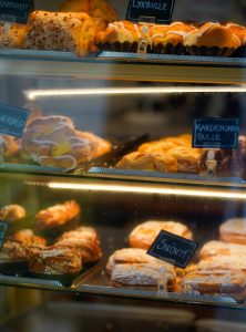 Selection of fresh pastries on display in a cozy bakery showcase.